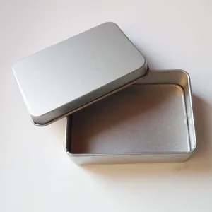Close-up detail of a silver matte rectangular tin box with its lid partially open