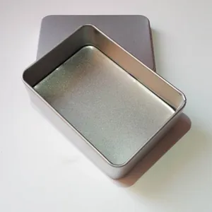 Close-up view of an open rectangular frosted silver metal tin box with a separate lid.