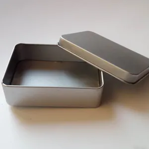 Detail view of a rectangular silver matte tin box with open lid for storage purposes.
