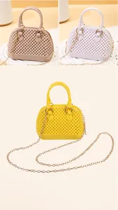 Detailed view of mini PVC jelly shell bags in khaki, white, and yellow colors