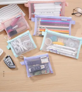 Various colorful mesh storage bags organized with pens, makeup, and electronic accessories