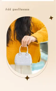 Elegant mini white PVC jelly shell handbag held in hand against a warm background