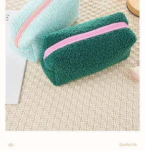 Detail view showing the soft plush texture of large capacity lamb wool makeup bags.