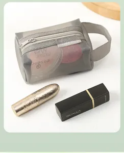 Detailed view of portable gray nylon mesh storage bag containing various cosmetics