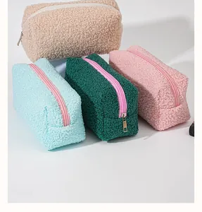 Detailed view of four colorful sherpa fleece cosmetic bags in various pastel shades