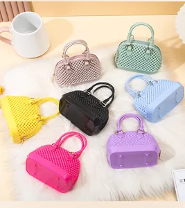Variety of colorful mini PVC jelly shell bags with studded texture on fluffy rug