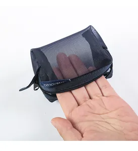 Close-up view of navy blue mesh mini coin pouch showing transparent texture and size