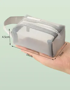 Detailed view of grey nylon mesh mini storage pouch with dimensions shown in hand