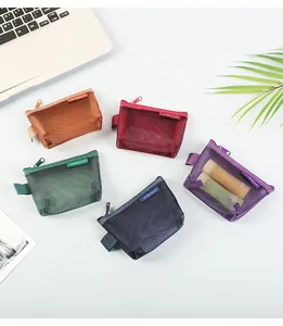 Close-up of colorful nylon mesh coin pouches for cards and keys displayed on a desk