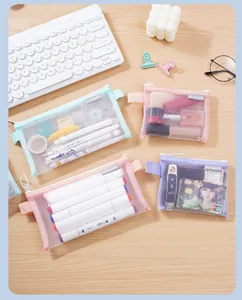 Macro detail of various colorful mesh storage bags with zipper closure for stationery items
