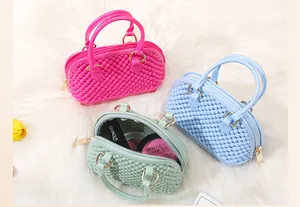 Detail view of mini PVC jelly shell bags in pink blue and mint green showing interior space