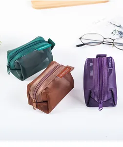 Small 3D mesh coin purses in green, brown and purple colors for organizing small items