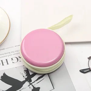 Piccolo portamonete rotondo rosa macaron con cerniera e cinturino per auricolari