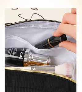 Close-up of corduroy makeup bag interior showing pockets and storage capacity