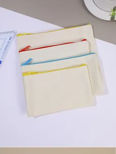 Detailed view of canvas zipper pouches in various sizes and colorful zipper accents.