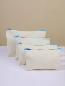 Detailed view showing four different sizes of beige canvas pouches with blue zippers