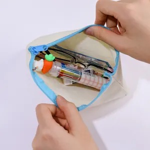 Hand opening a durable cream canvas zipper pouch filled with colorful stationery