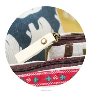 Close-up detail of a vintage cotton linen coin purse with bronze zipper and ethnic patterns