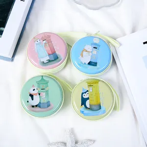 Set of four round tinplate coin purses featuring cute cartoon animal and postbox designs