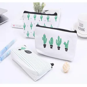 Cactus pattern canvas pencil case with green stripes on a bright desk setup