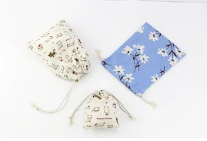 Three cute cotton linen drawstring pouches with printed cat and floral patterns