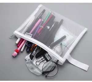 Detailed view of white A5 mesh storage bag filled with pens and stationery items