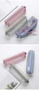 Macro view showing the fine mesh texture of aesthetic pencil cases in pastel colors.