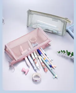 Close-up of translucent mesh pencil cases with various stationery items spilling out