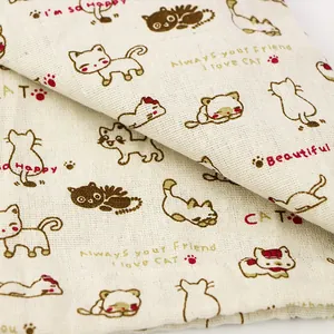 Detailed view of soft cotton linen fabric with a cute cartoon cat print for drawstring bags
