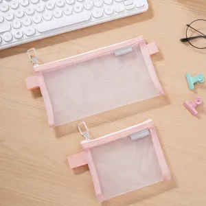 Two portable pink mesh storage bags for makeup and stationery shown on a desk