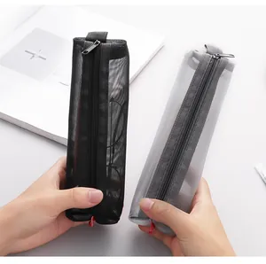 Close-up of black and grey transparent mesh pencil cases being held to show material texture