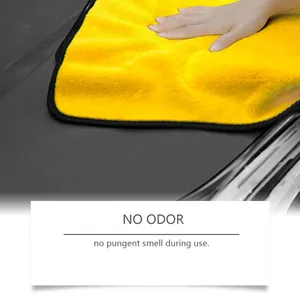 Detail view of yellow microfiber towel cleaning a car surface with no odor feature