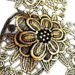 Detailed close-up macro view of gold-stamped floral lace embroidery applique detail