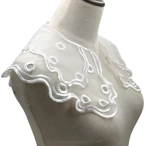 Detailed close-up view of the double-layered white embroidered organza lace collar.