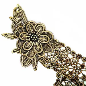 Detail view of gold embroidered lace floral applique for dress and collar decoration