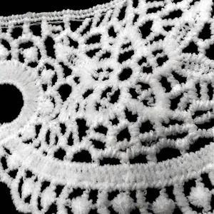 Close-up macro view of white water-soluble lace showing 3D hollow embroidery texture