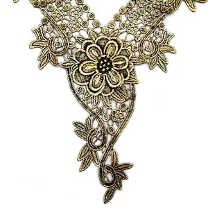 Close-up detail of gold water-soluble lace embroidery featuring intricate floral patterns