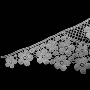 Close-up of white water-soluble lace floral trim with intricate hollow-out embroidery