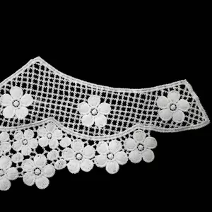 Detailed macro view of white water-soluble lace collar with delicate 3D floral embroidery