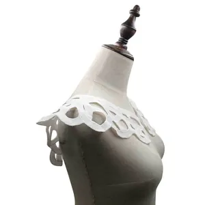 Macro detail of white water-soluble milk silk lace collar with hollow embroidery design