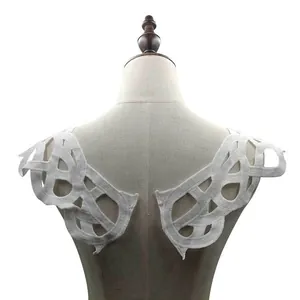 Close-up detail of white water-soluble lace shoulder collar with hollow embroidery