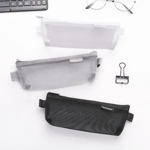 Minimalist transparent mesh pencil cases in white grey and black on a white desk background