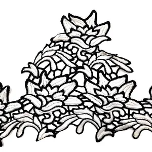 Detail view showing the black and white floral water-soluble lace embroidery pattern