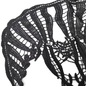 Detailed macro view of black skull water-soluble lace embroidery texture.