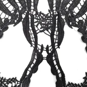 Close-up detail of black water-soluble lace skull embroidery patch for DIY crafts
