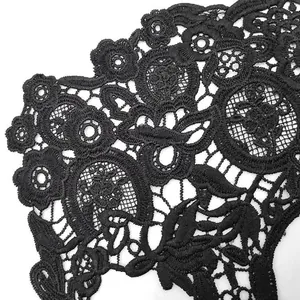 Detailed macro shot of black milk silk water-soluble lace embroidery with floral patterns