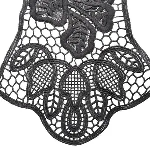Macro shot of black water-soluble lace collar with embroidery detail