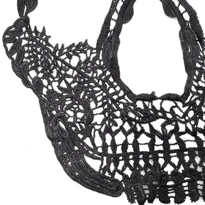 Detailed close-up of black milk silk embroidery skull lace patch for DIY crafts