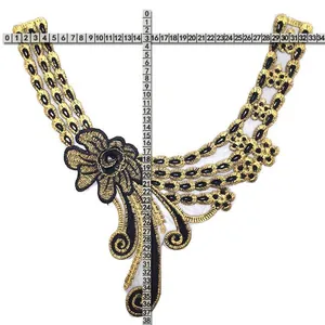 Detailed view of gold and black embroidered lace collar flower with scale measurements
