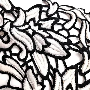 Close-up of two-tone water-soluble lace patch with intricate floral embroidery details